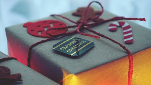 Close-Up Photo of a Gift Box Wrapped With Red String