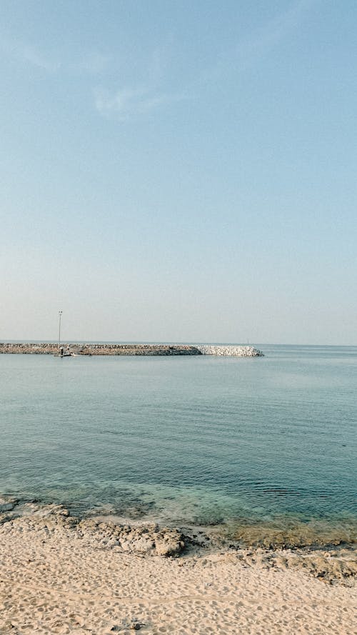 A Rocky Pier seen from the Beach 