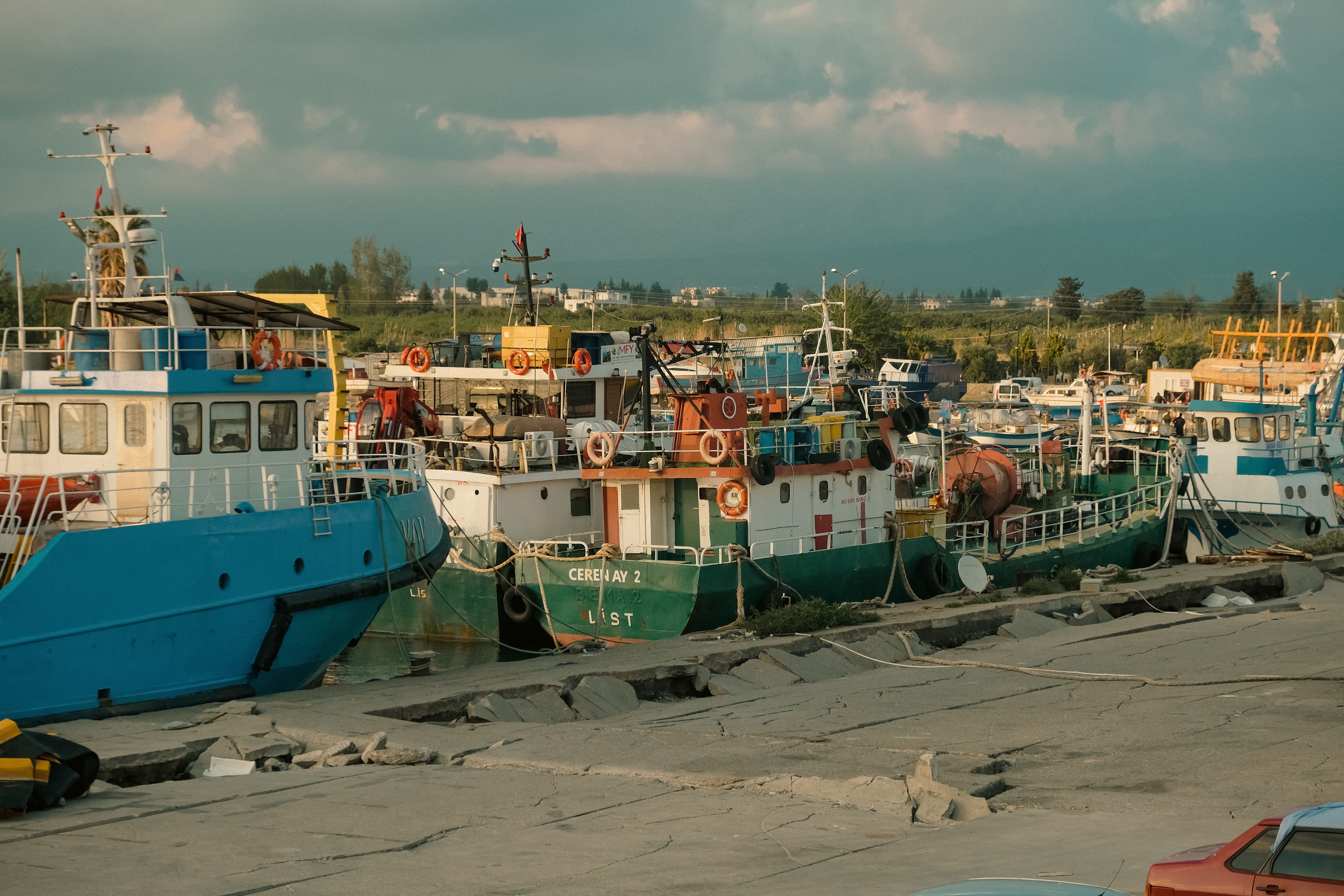 Fishing and excursion boats moored at Latchi harbour with the Akamas hills behind