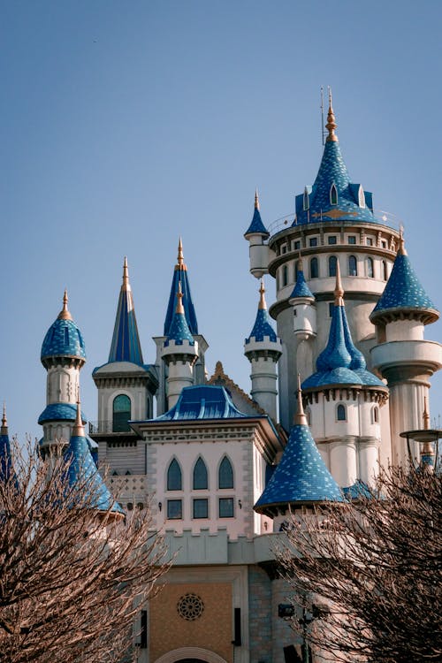 A castle with blue turrets and a blue roof