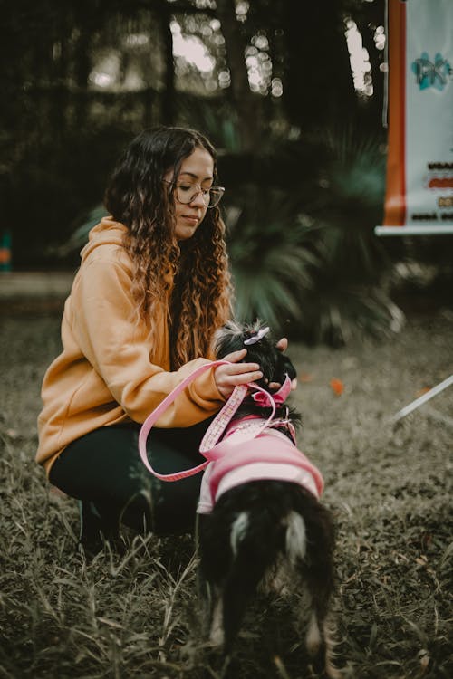 Woman Patting Dog in Clothes