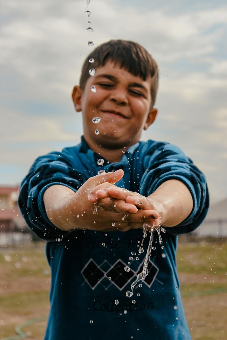 Smiling Boy Splashing Water