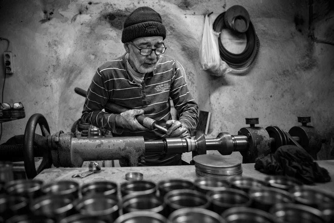 Elderly Man Doing Metalwork at the Workshop