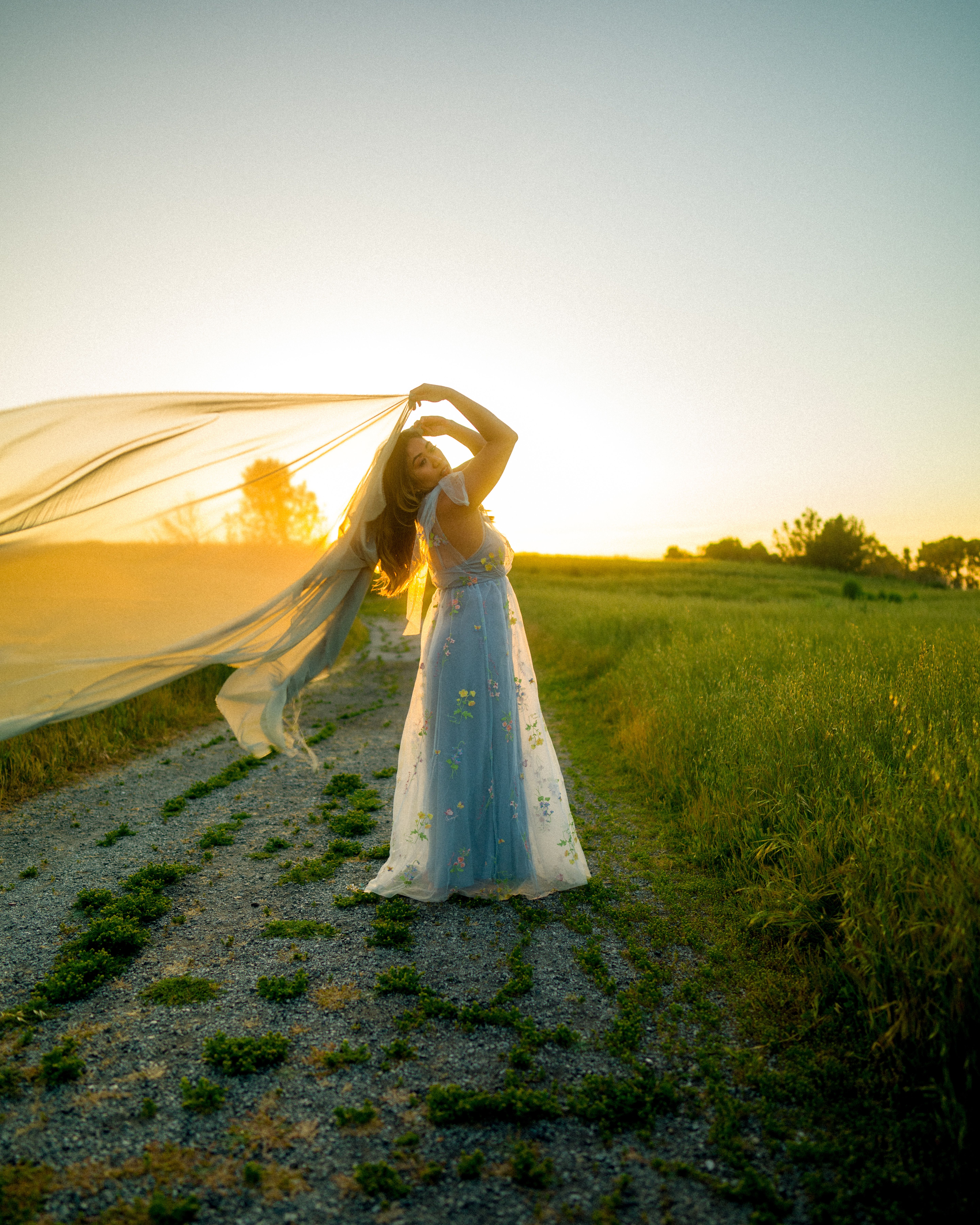Woman in Dress Posing on Dirt Road at Sunset  Free Stock Photo