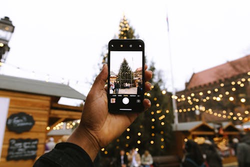 使用android智能手机拍照的圣诞树的人