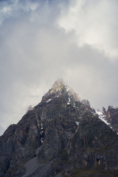 Free Stunning view of a rugged mountain peak under dramatic clouds in Cusco, Peru. Stock Photo