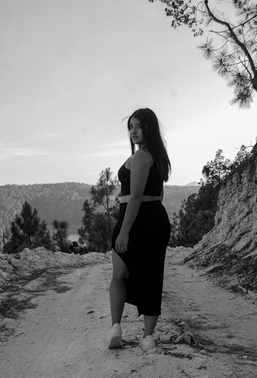 Black and White Picture of a Woman in a Summer Outfit on the Road 