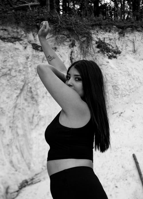 Young Woman Posing Under a Cliff