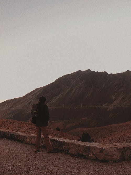 Man in Black Jacket Standing on Mountain