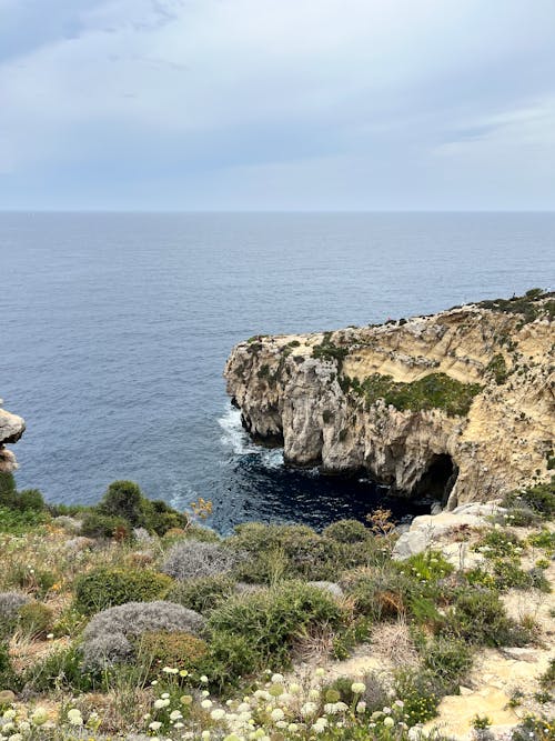 Scenic View of Sea and Rocky Coastline 