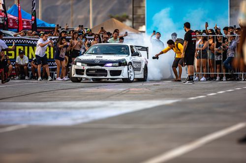 Free High-energy car drifting event with spectators capturing the thrilling action. Stock Photo