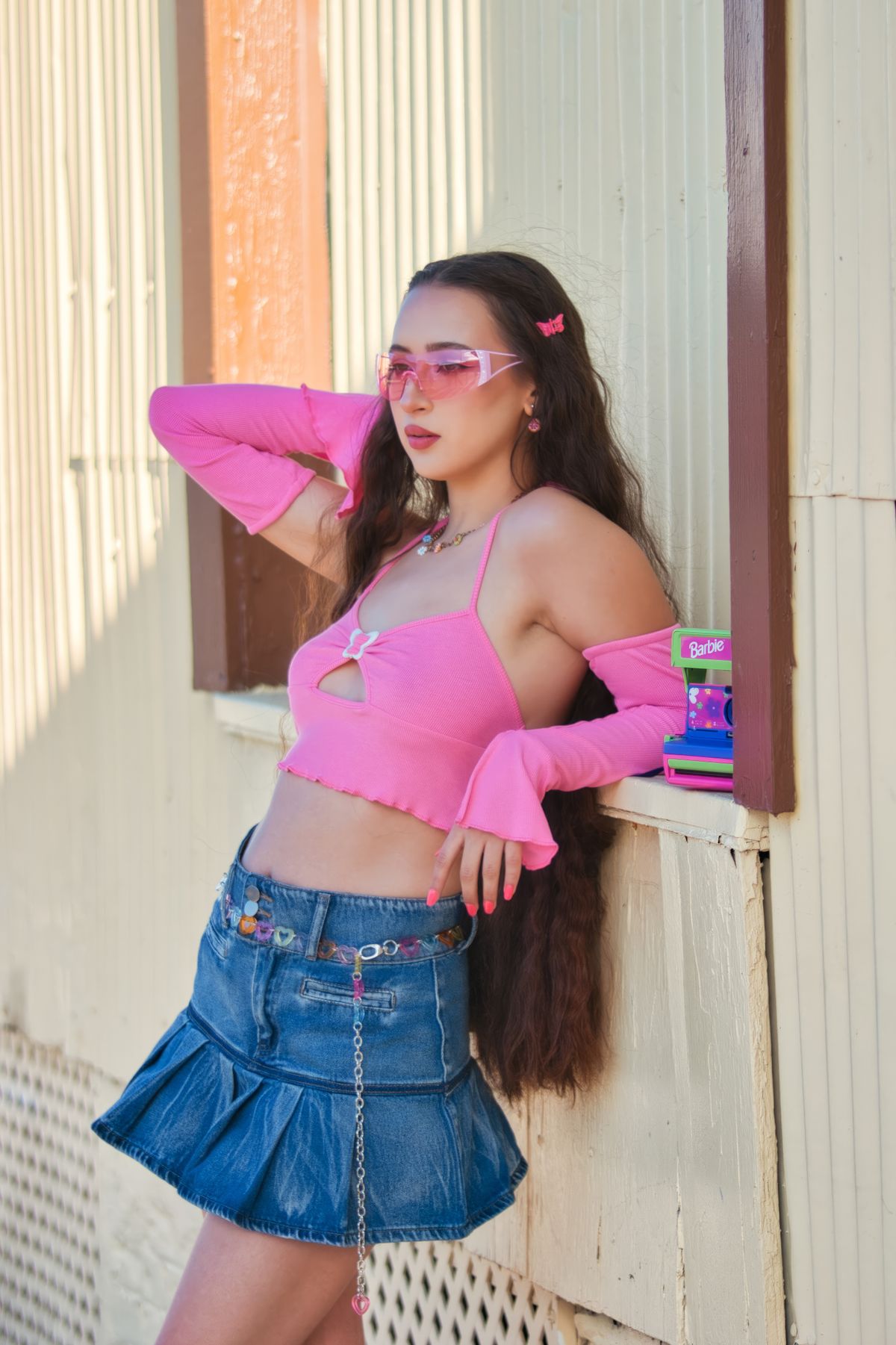 Young Woman Posing in a Pink Crop Top and Denim Skirt · Free Stock Photo