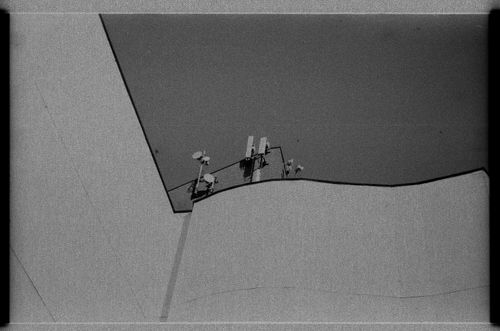 Free Minimalist black and white image showcasing modern architecture and antennas. Stock Photo