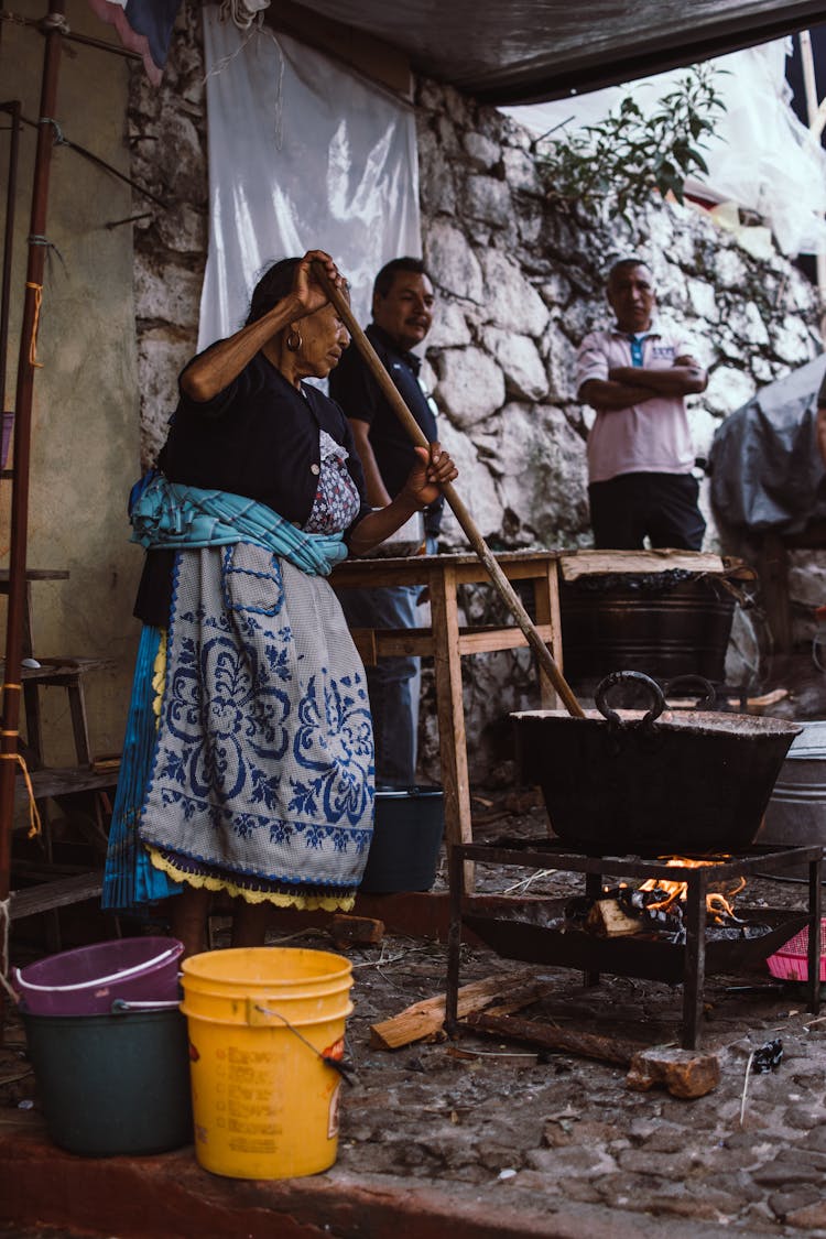 A Woman Cooking In An Outdoor Kitchen