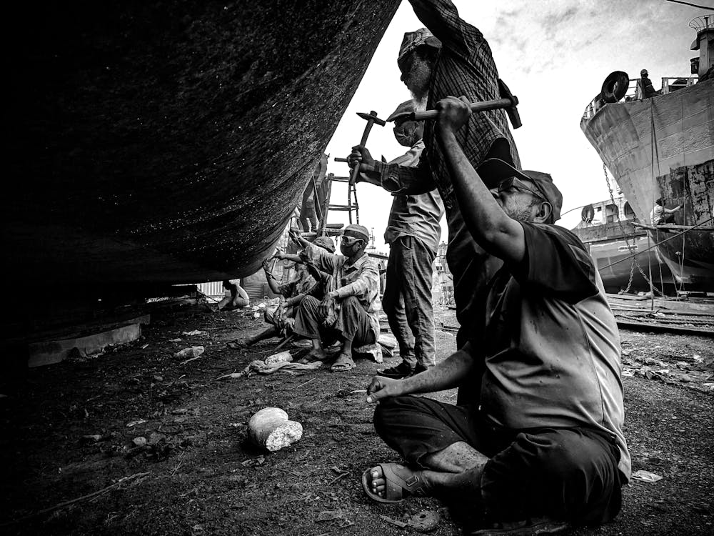 Men Working by Boat at Dock