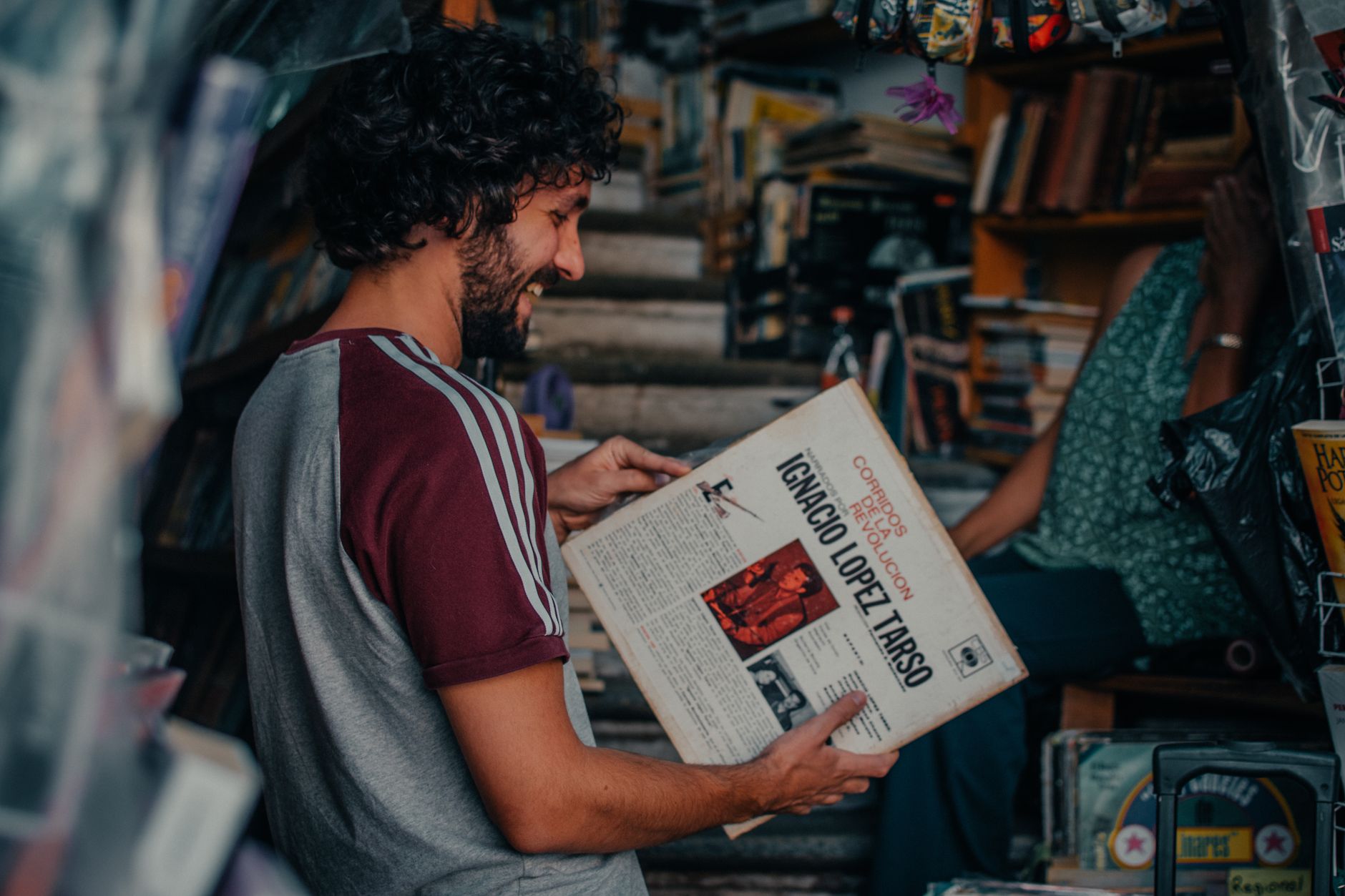 A man enjoys browsing vintage records in a vibrant market in Guanajuato, Mexico.