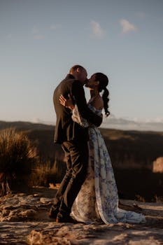A couple sharing a romantic moment in the Blue Mountains National Park, NSW, Australia at sunset.