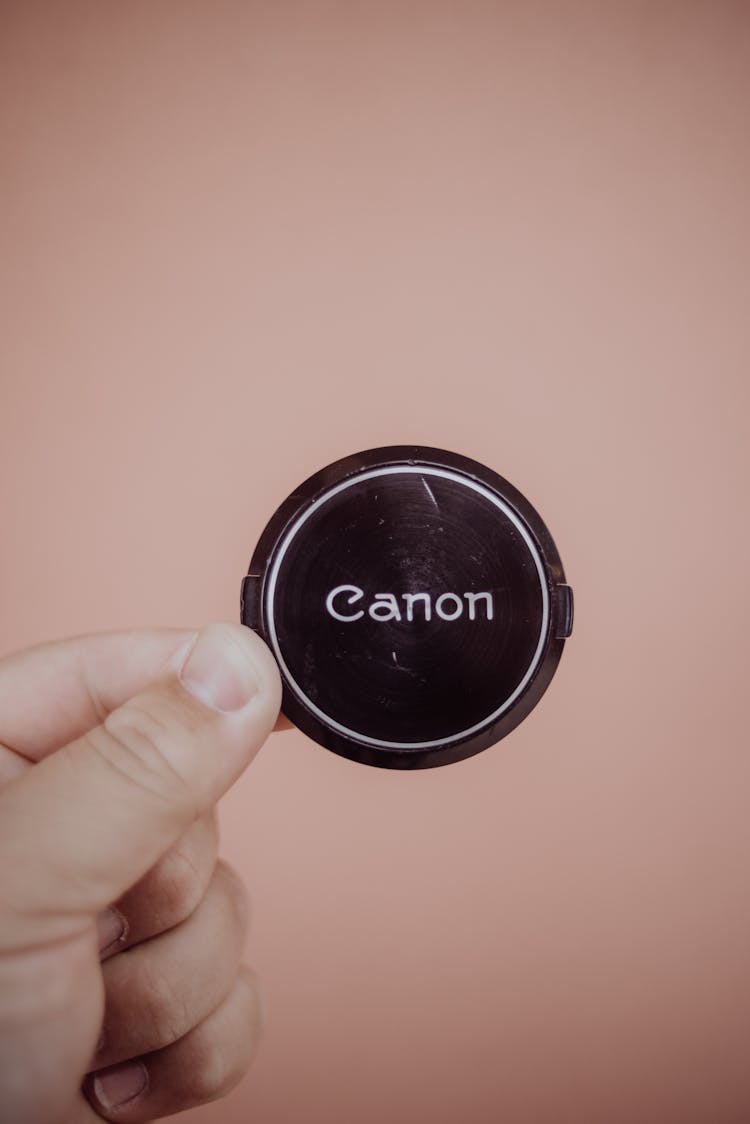 Fingers Holding Canon Lens Cover