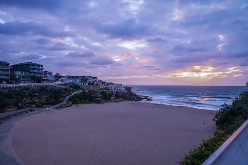 White Sandy Beach Under Cloudy Sky