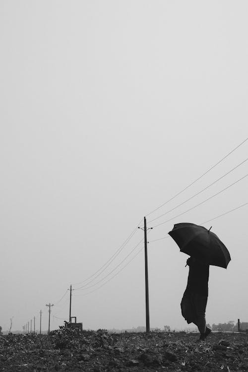Man in Coat with Umbrella