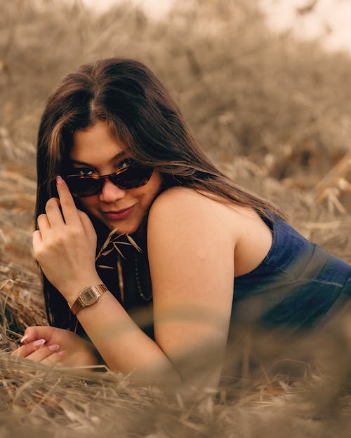 Woman Posing in Sunglasses and Lying Down