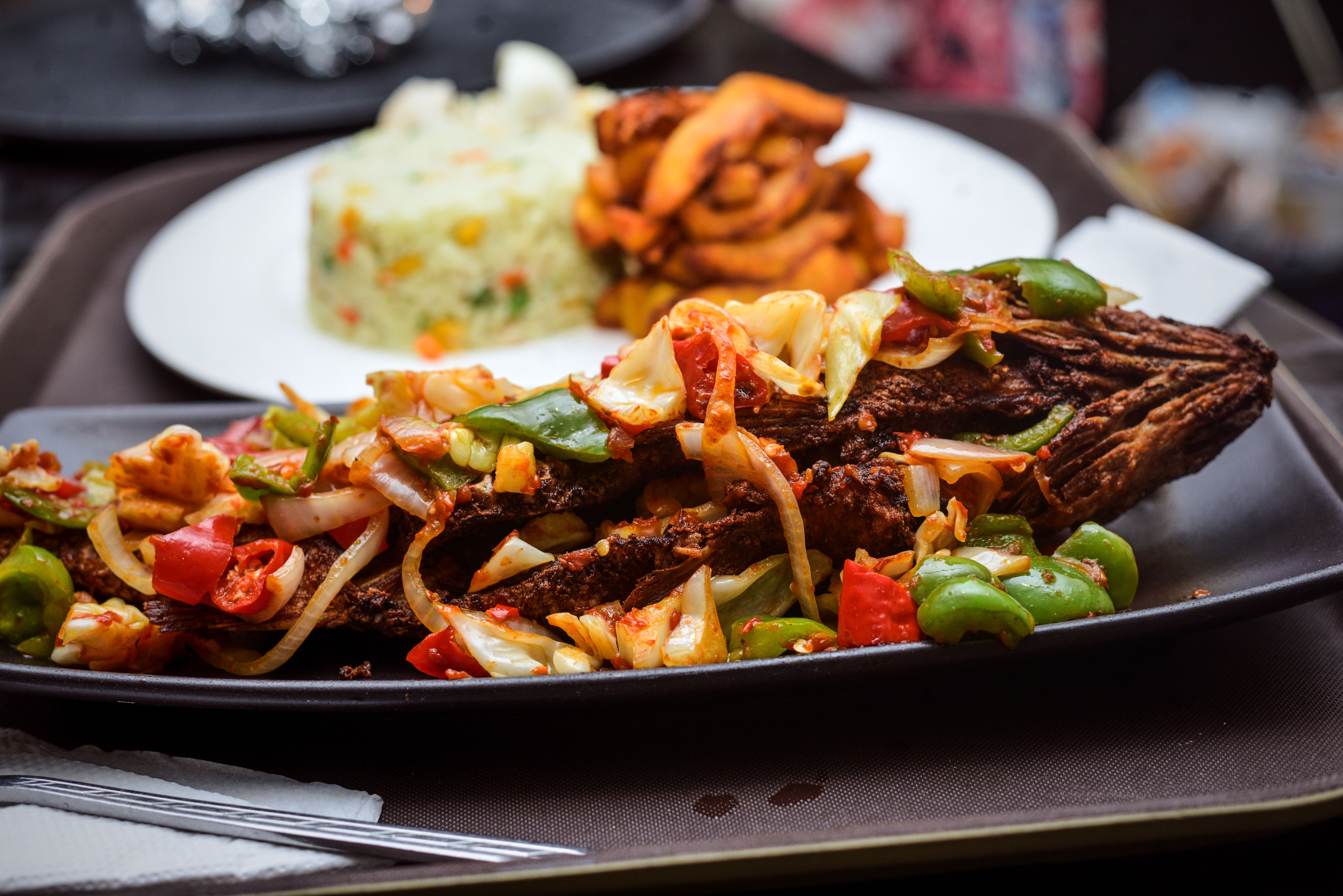 vibrant street food near UHAS with students eating jollof rice and fried fish