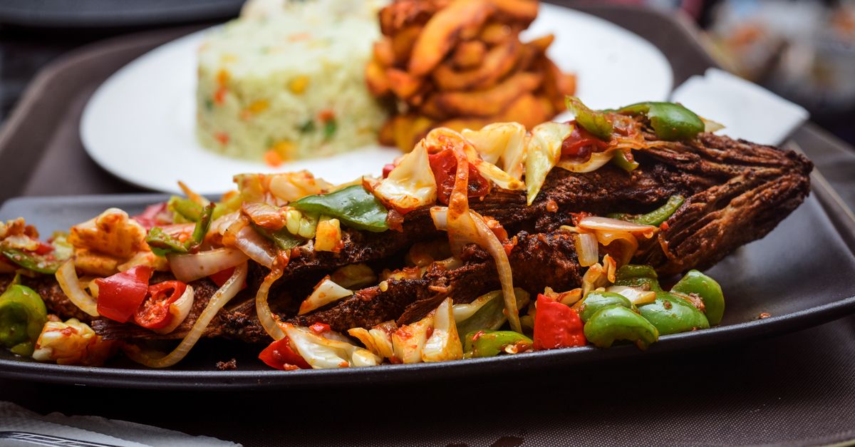 vibrant street food near UHAS with students eating jollof rice and fried fish