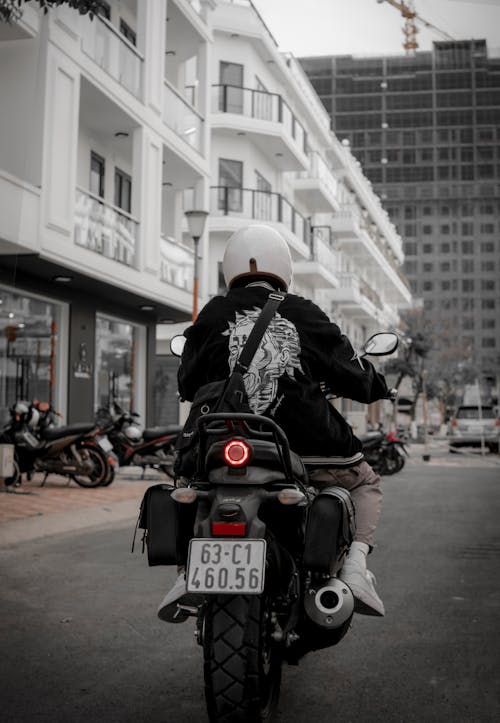 Man Riding Motorcycle in City