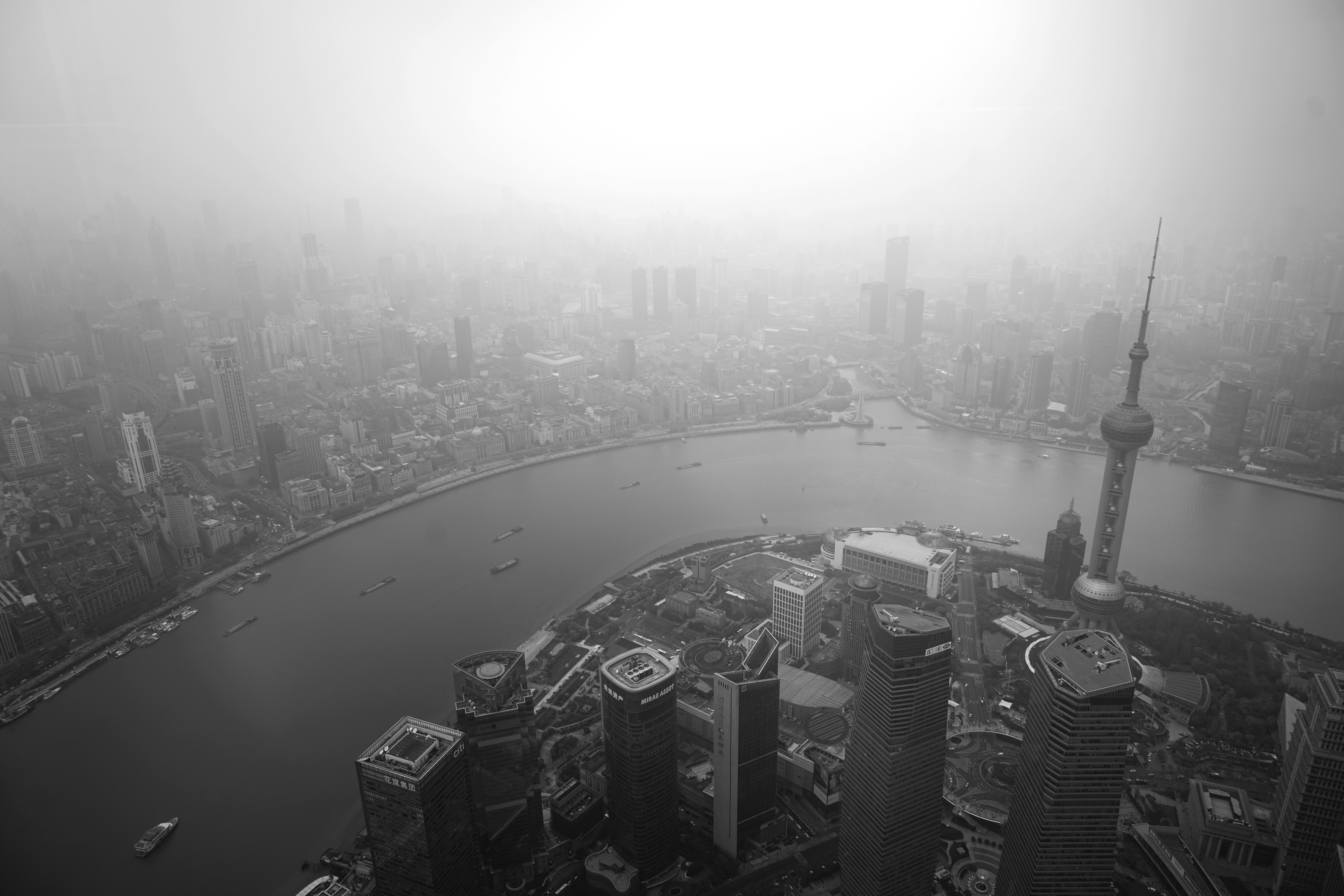 Aerial view of the Shanghai skyline shrouded in heavy mist, black and white
