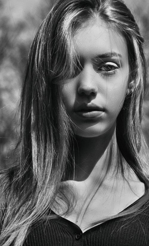 Free Striking black and white portrait of a young woman in natural sunlight. Stock Photo