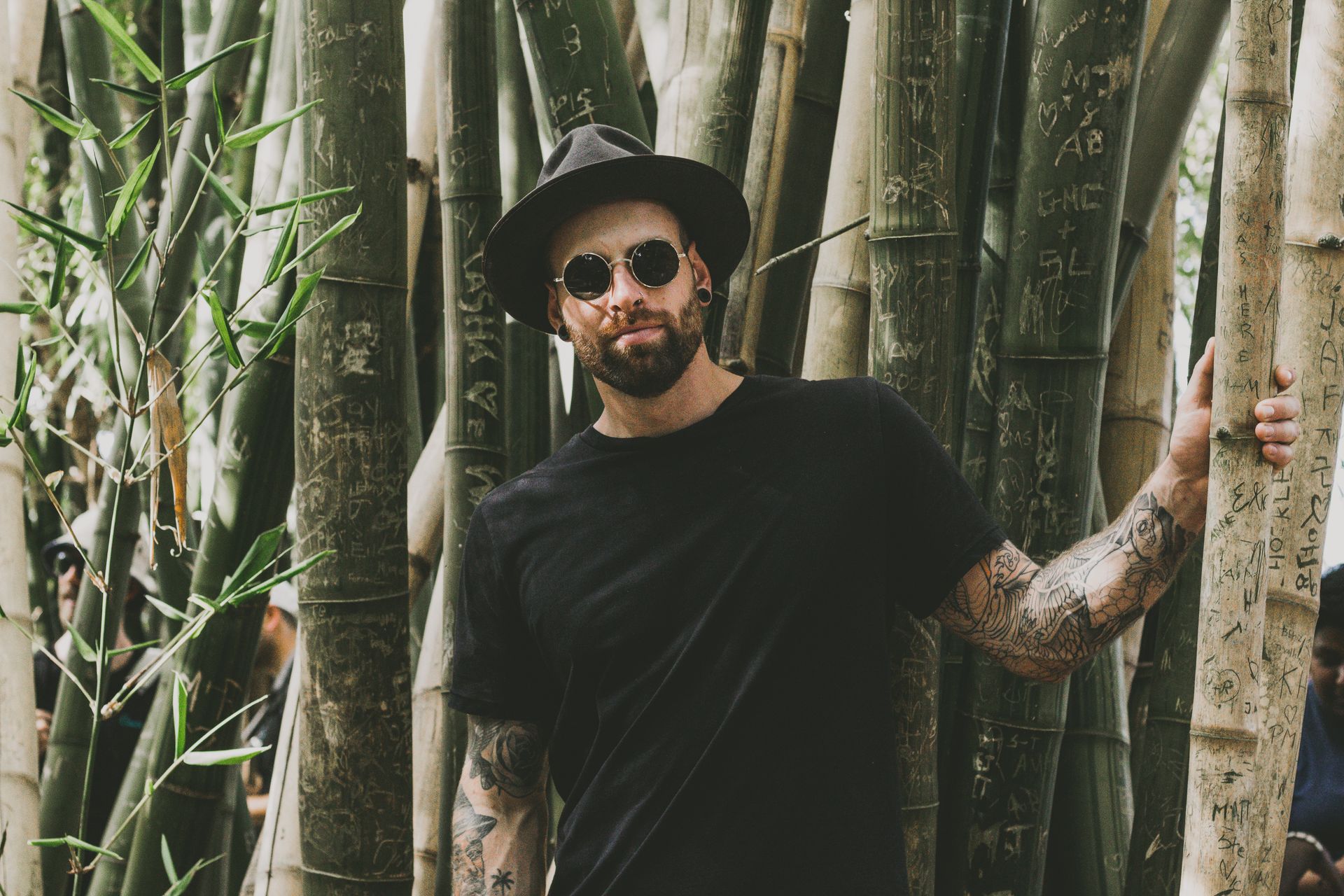 Photo of Man Standing Near Bamboo Trees