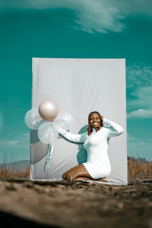 Young Woman Holding Birthday Balloons Outdoors 