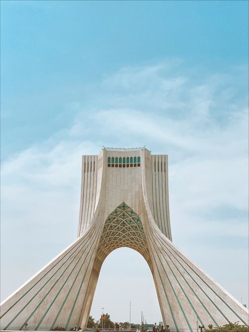 Free Iconic Azadi Tower in Tehran under a vibrant blue sky, showcasing modern Iranian architecture. Stock Photo