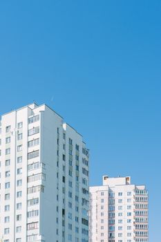 High-rise residential buildings under a clear blue sky in Minsk, Belarus.
