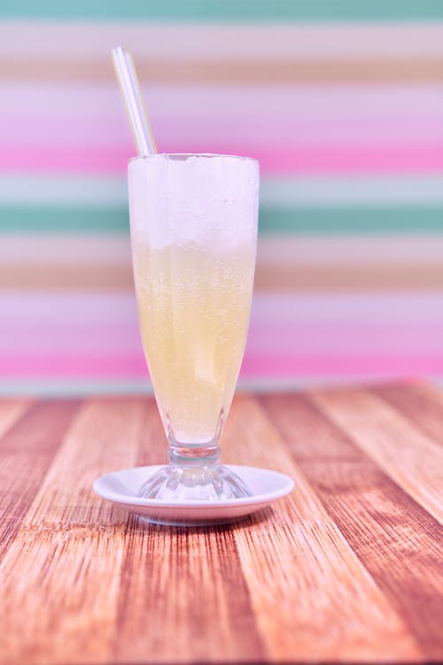 Cold Drink with Straw in Glass on Table