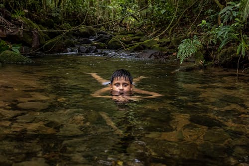 Free Boy Lying Down and Posing in Water Stock Photo