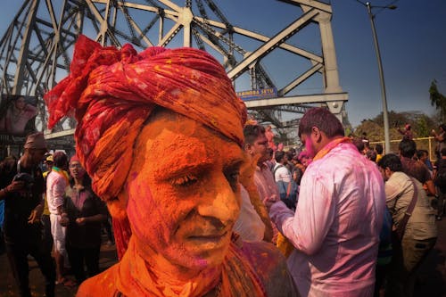 Man Covered in Colorful Powder during a Festival in India