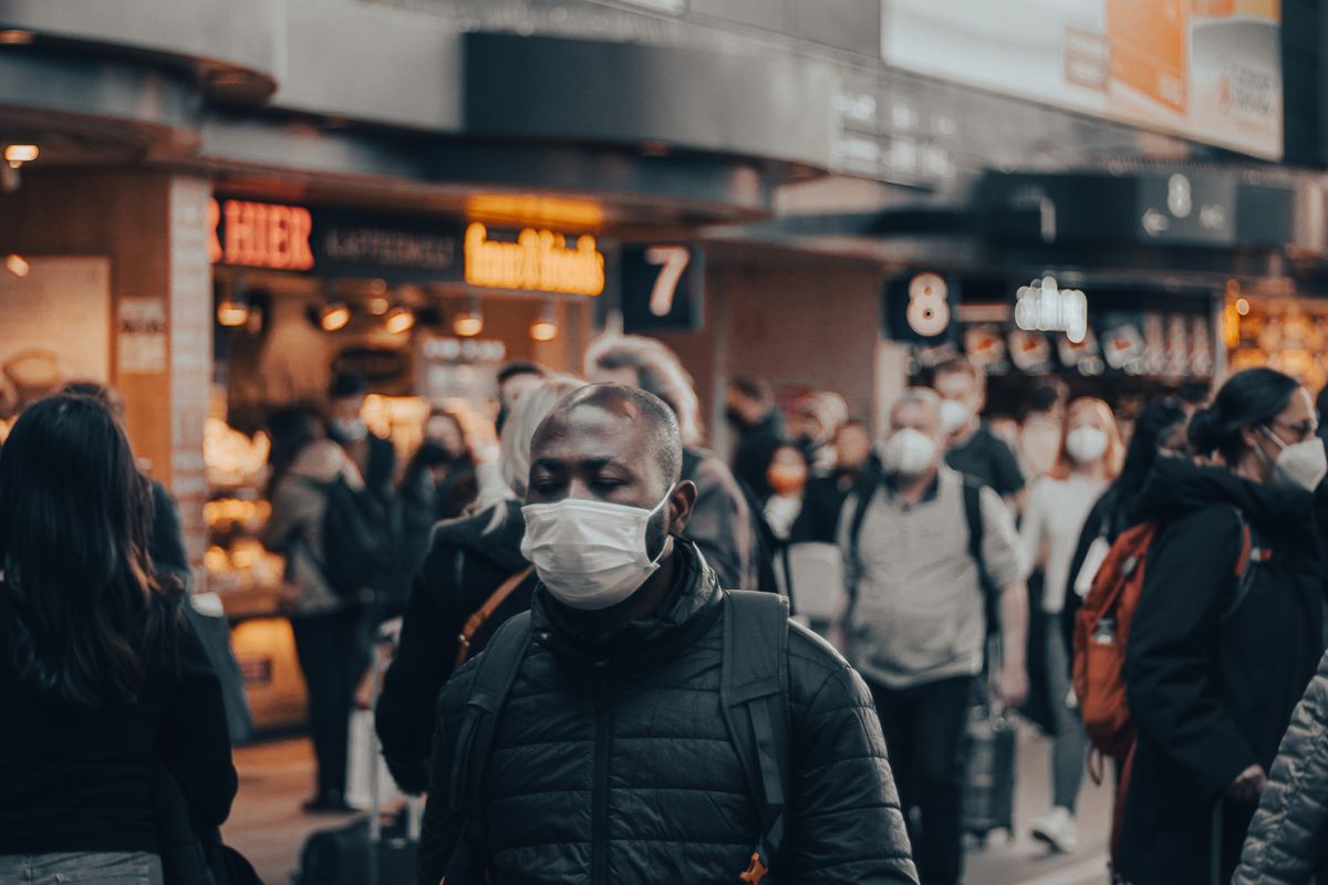 Passengers walking through a busy airport terminal