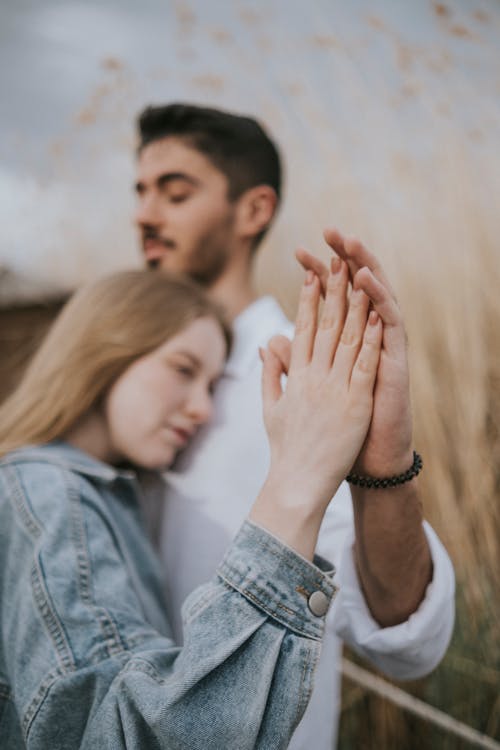 Couple Standing with Hands Together