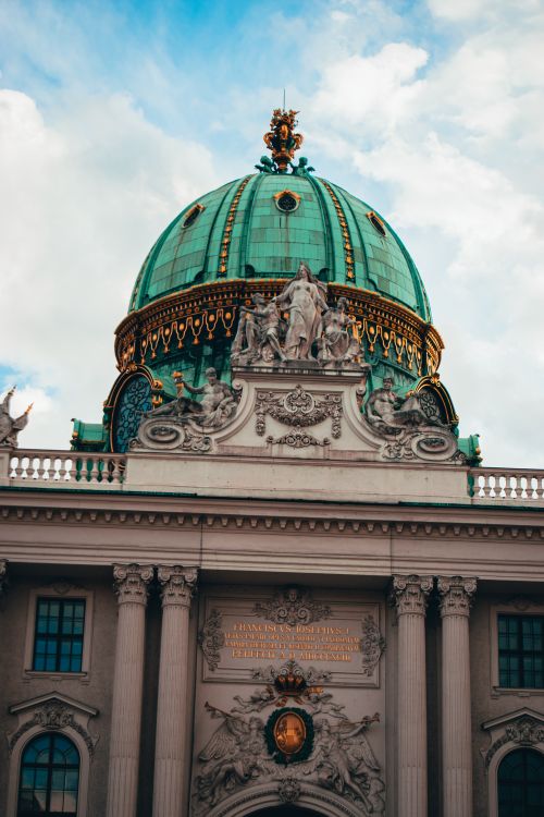 Free Capture of the ornate dome of Hofburg Palace, showcasing Vienna's historic architecture. Stock Photo