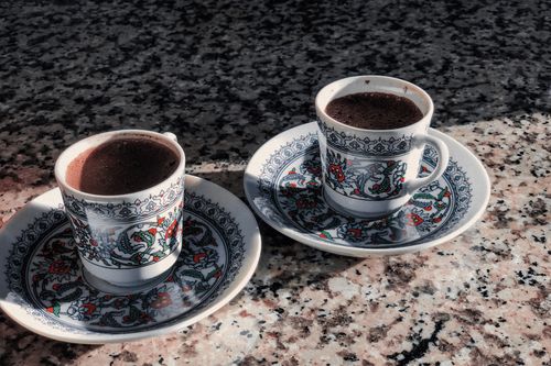 Free Two ornate coffee cups with intricate designs on a marble surface. Stock Photo