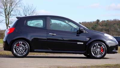 Dark hatchback in profile on a country road, photo by Mike Bird on Pexels