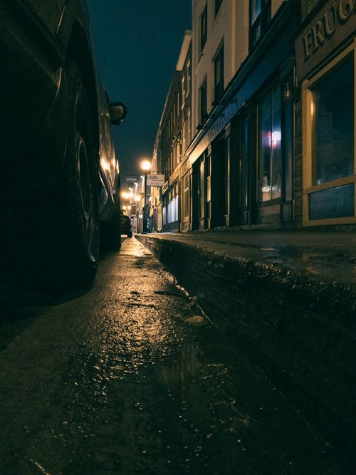 Free Moody urban street in St. John's, NL, Canada, illuminated by soft streetlights at night. Stock Photo