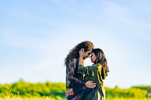 Young Couple Hugging in Summer Field
