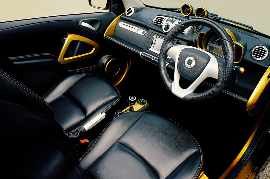High-quality photo of a luxury car interior featuring leather seats and gold accents.