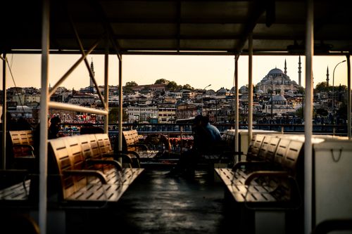 Free A picturesque view from a ferry overlooking Istanbul's iconic skyline at sunset. Stock Photo