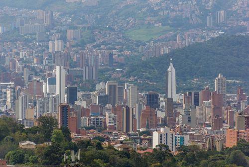 Free A stunning aerial view of Medellín's urban landscape, showcasing its distinctive architecture amidst lush greenery. Stock Photo