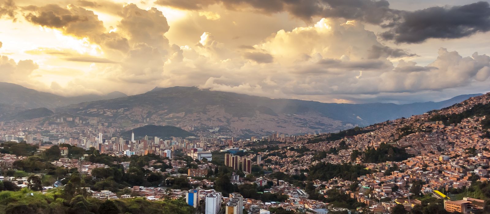 Breathtaking view of Medellin's skyline at sunset with dramatic clouds and vibrant colors. — flights from Madrid to Medellin