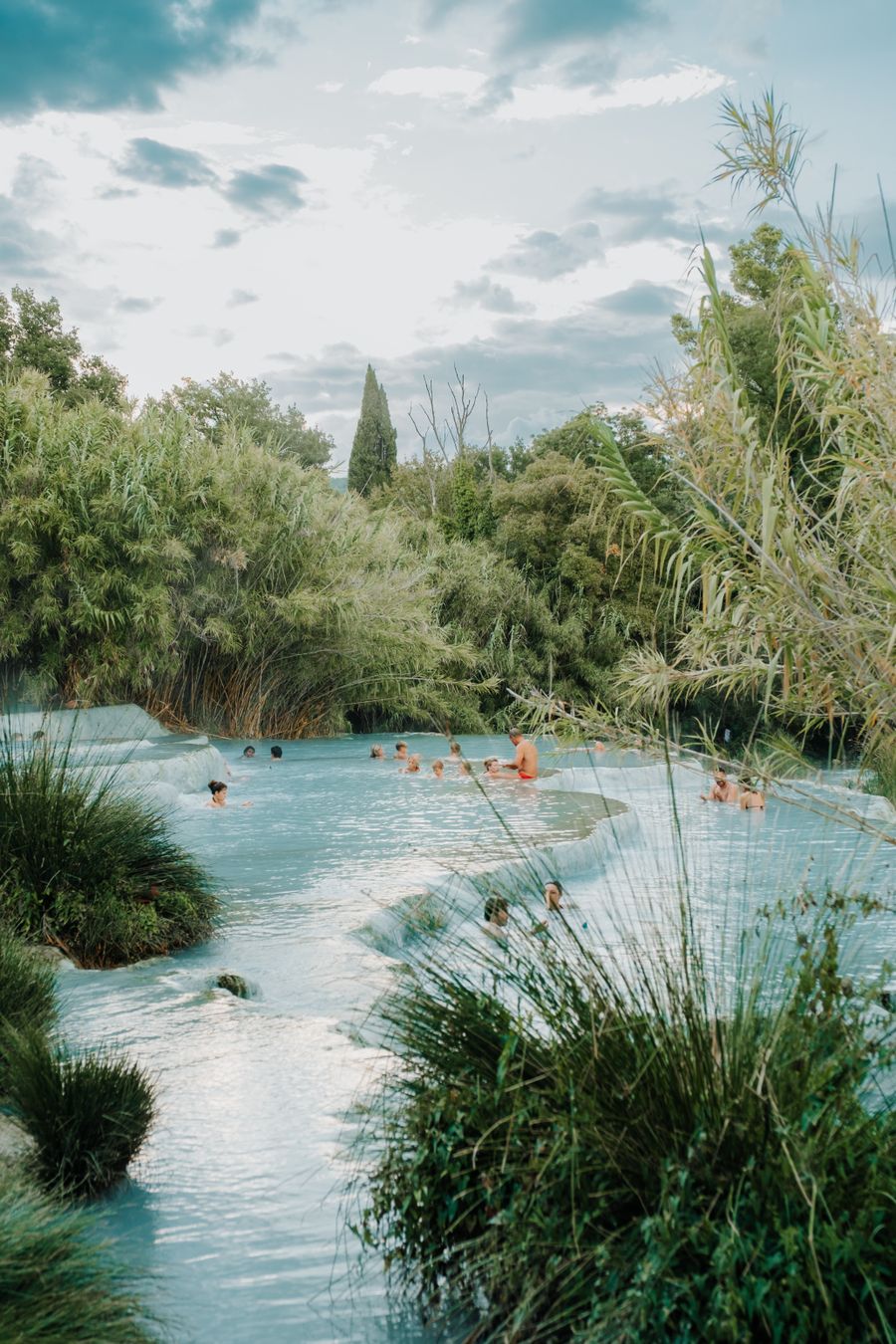 Guests relaxing at a tropical resort pool on a wellness holiday