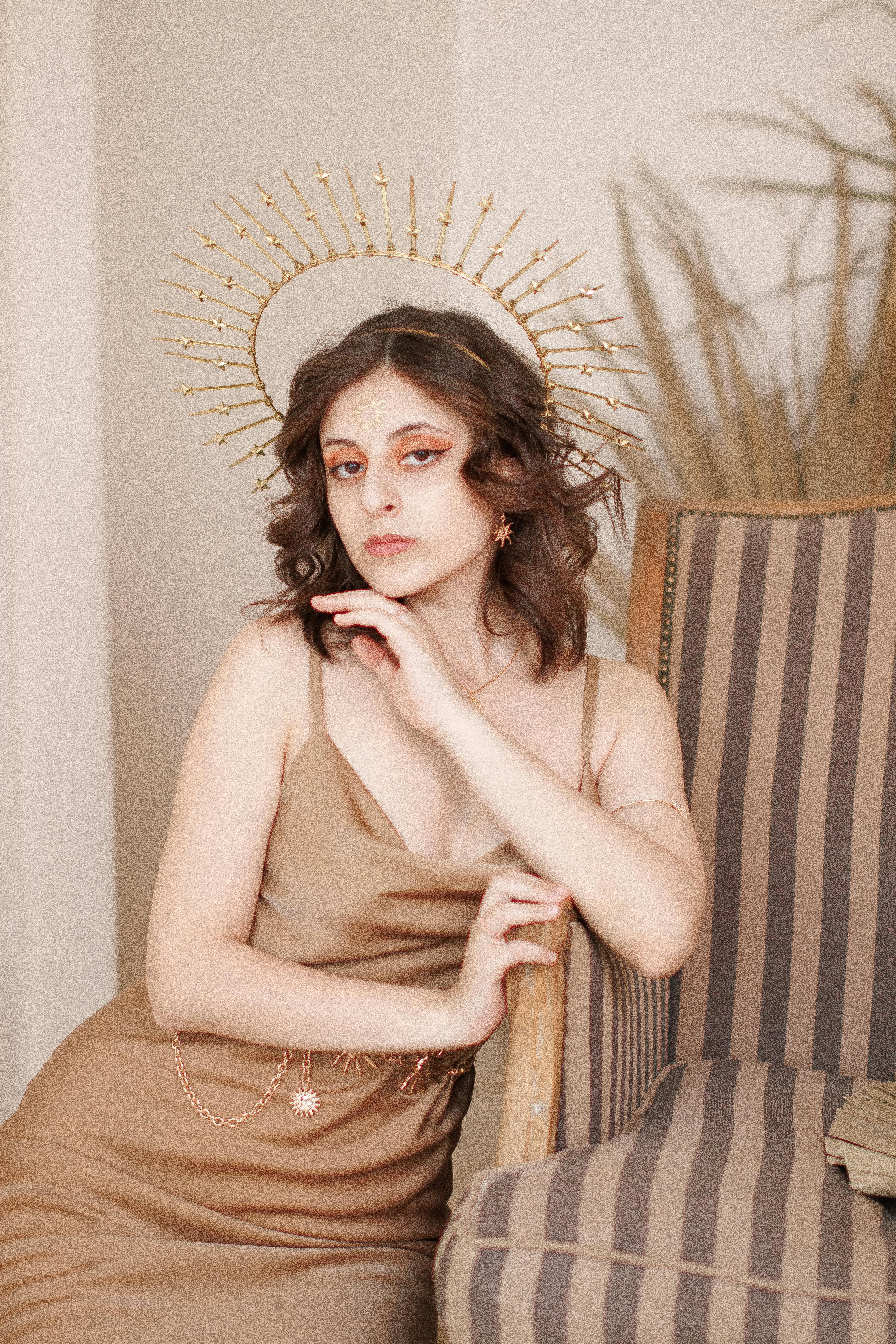 young woman posing in an elegant dress and a crown